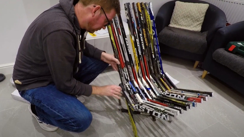 man making hockey stick chair