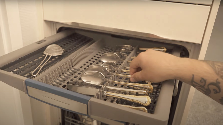 woman washing silverware with foil