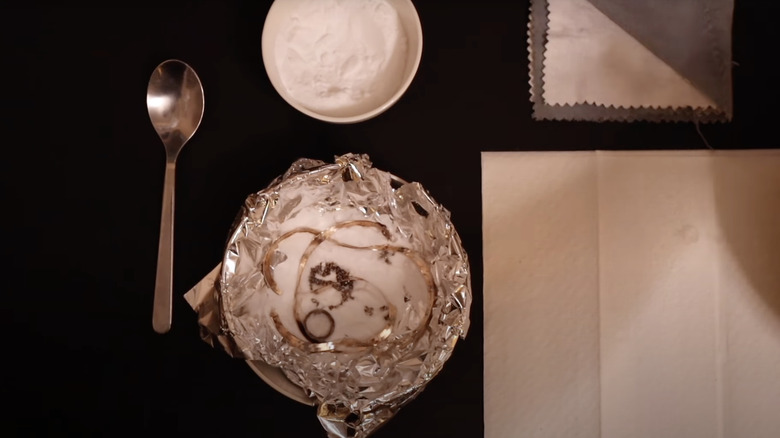 jewelry soaking in aluminum foil bowl