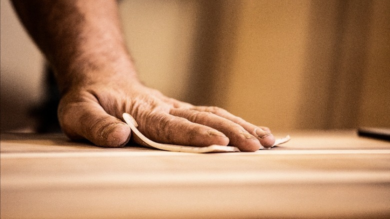 Person sanding wood