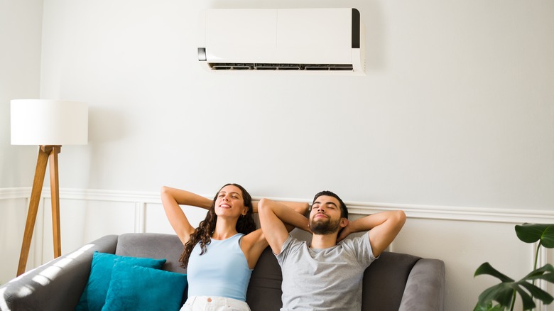 couple relaxing with ac unit 