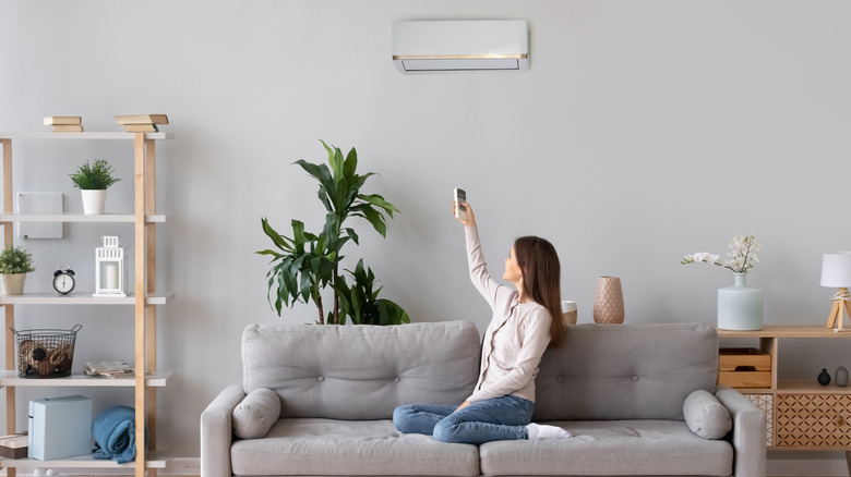 woman on couch with split system air con