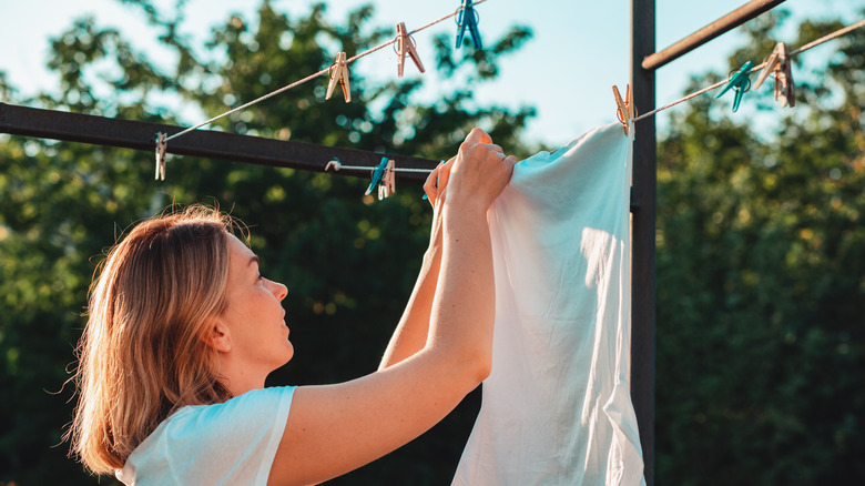 Woman hang drying laundry