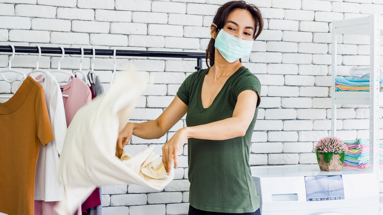 Woman shaking out clothes