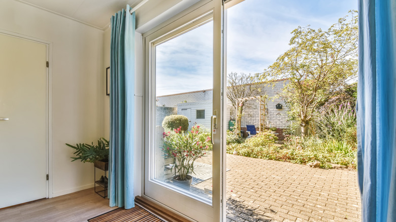 sliding glass door with blue curtains