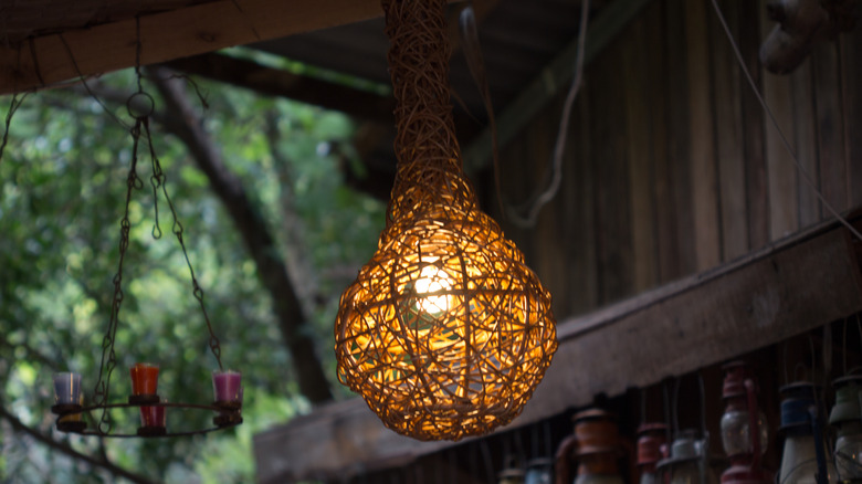 Twine lamp hanging from a ceiling rafter