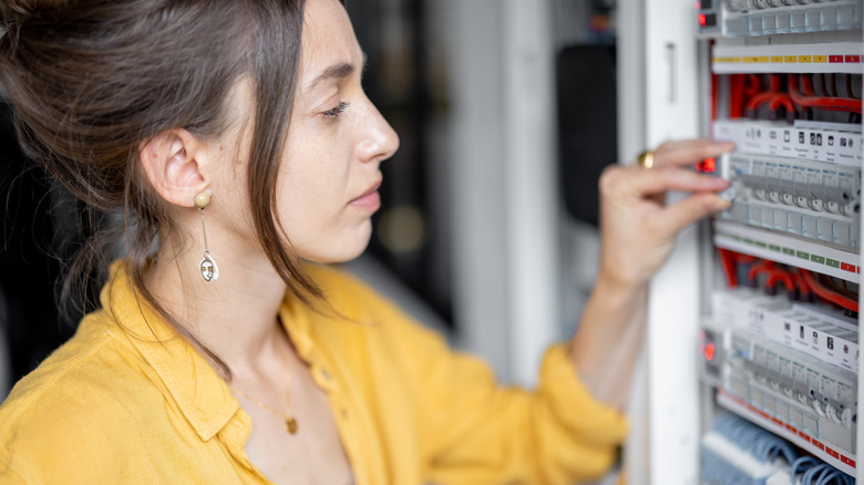 Women checking breaker box