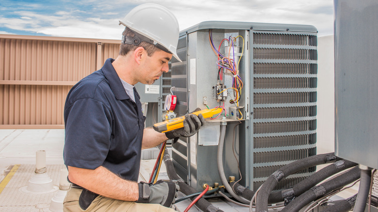 Person repairing HVAC unit