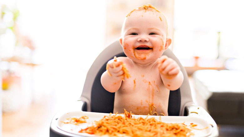messy baby eating spaghetti
