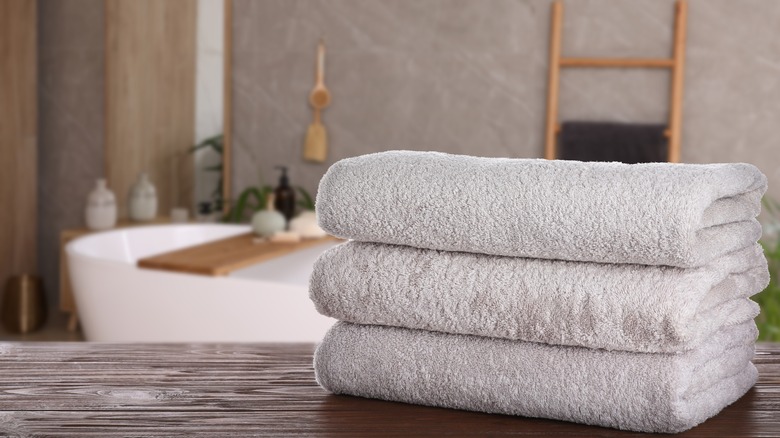 Folded white towels on surface in bathroom