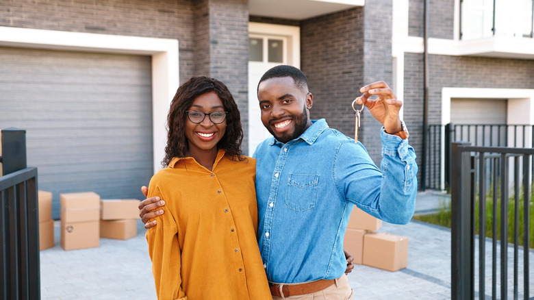 Couple standing outside home