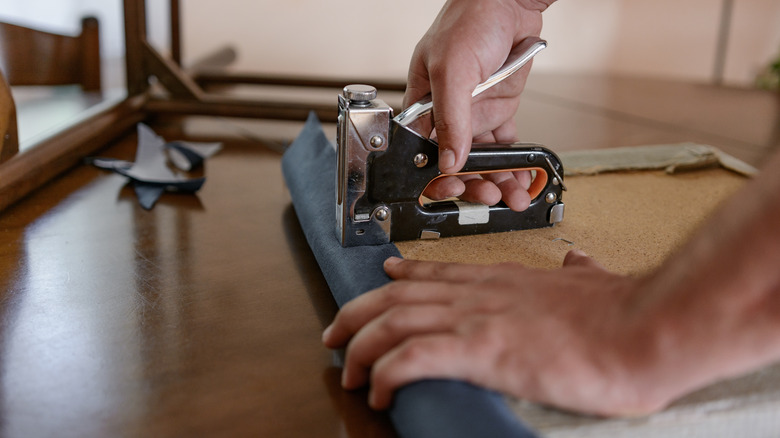 person upholstering seat