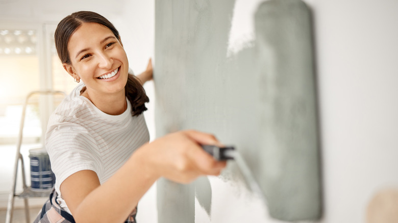 Woman painting a wall