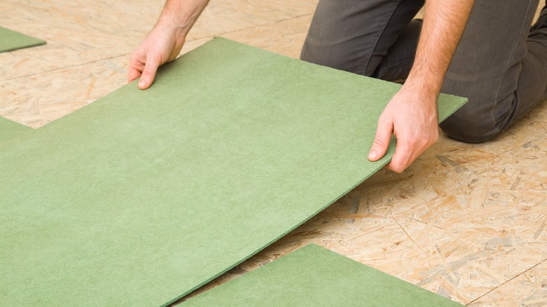 Laying down insulation under flooring