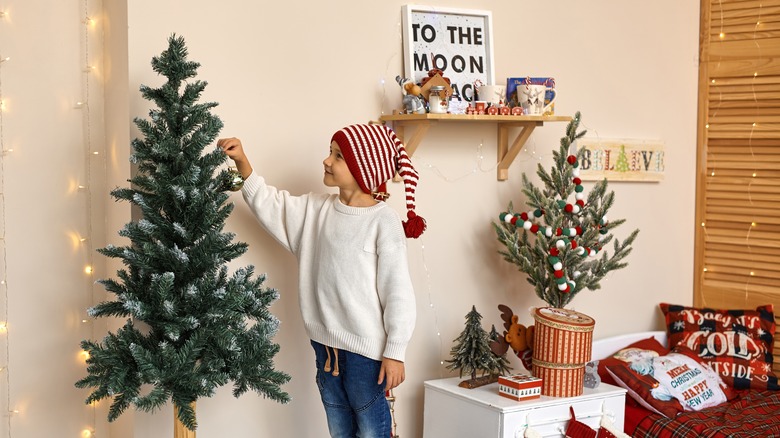 Boy decorating tree