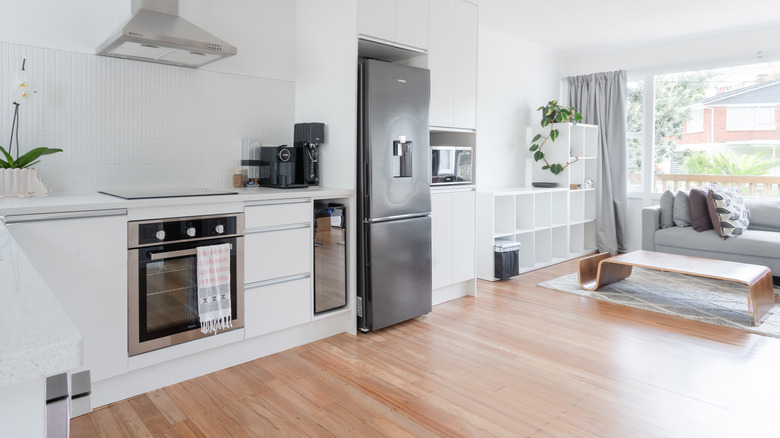 Kitchen with range, refrigerator, microwave, and wine cooler.