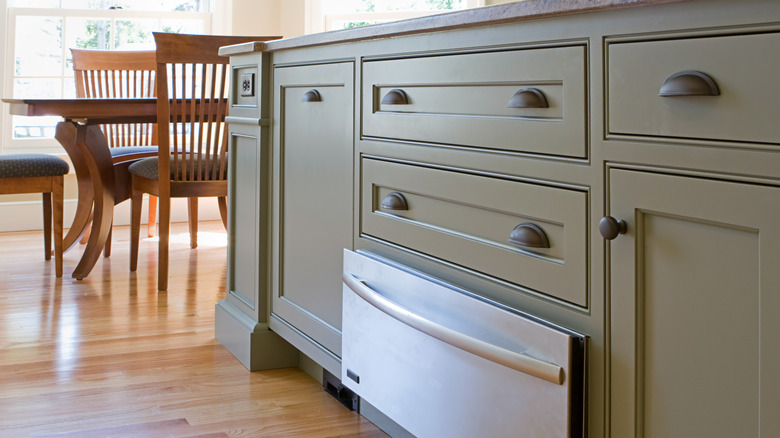 Warming drawer at base of wood kitchen island