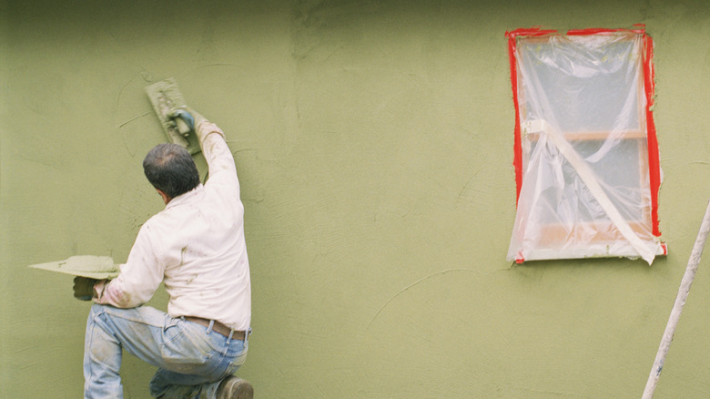 Worker applying stucco mix