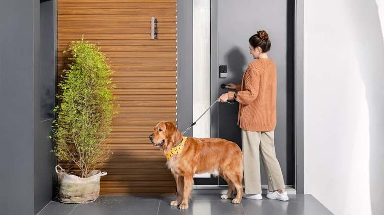 Woman opening door with dog