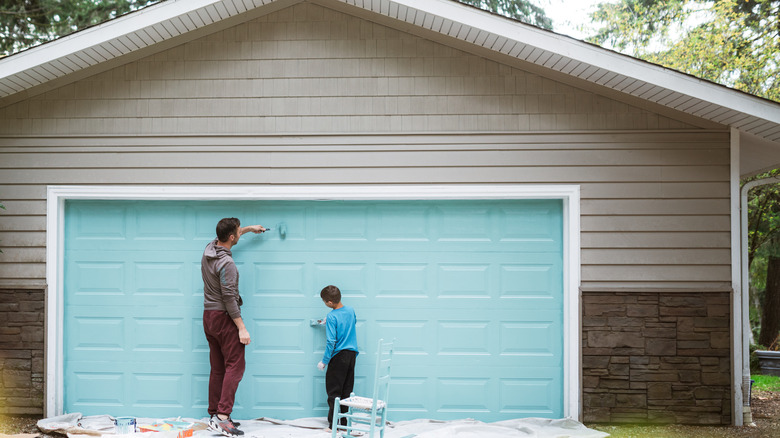 People painting garage door