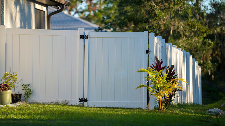 White vinyl fence on residential property.