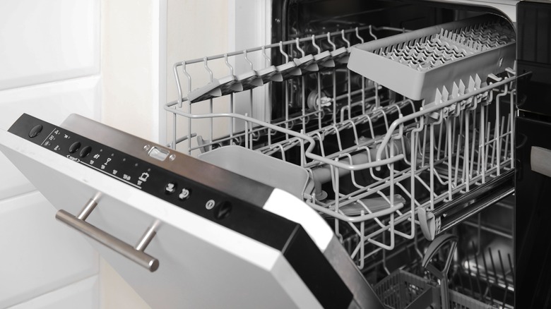 Open dishwasher showing empty racks