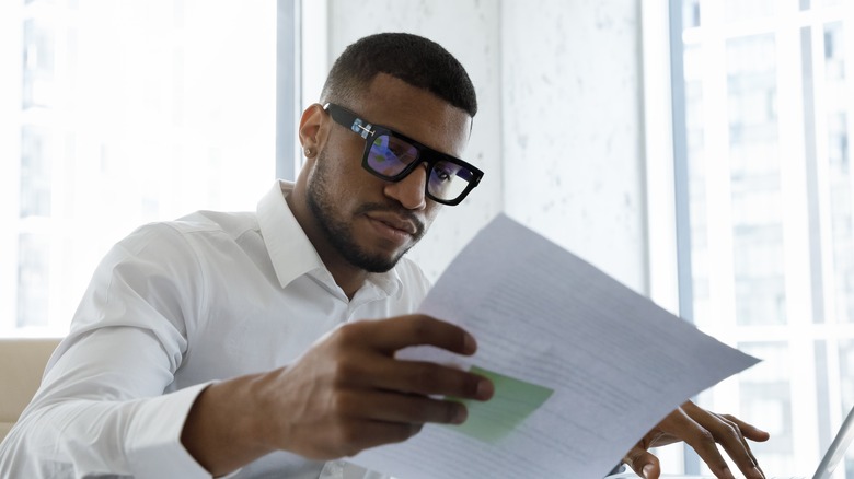 man looking at papers