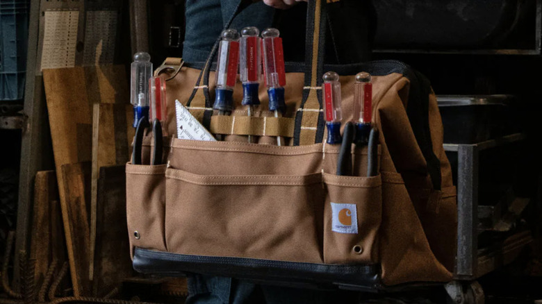 Carhartt tool bag being used in a garage