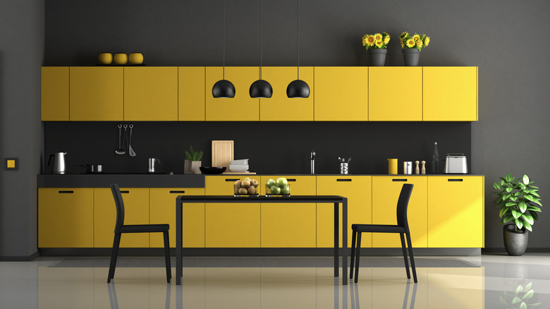 Dark kitchen with yellow cabinets