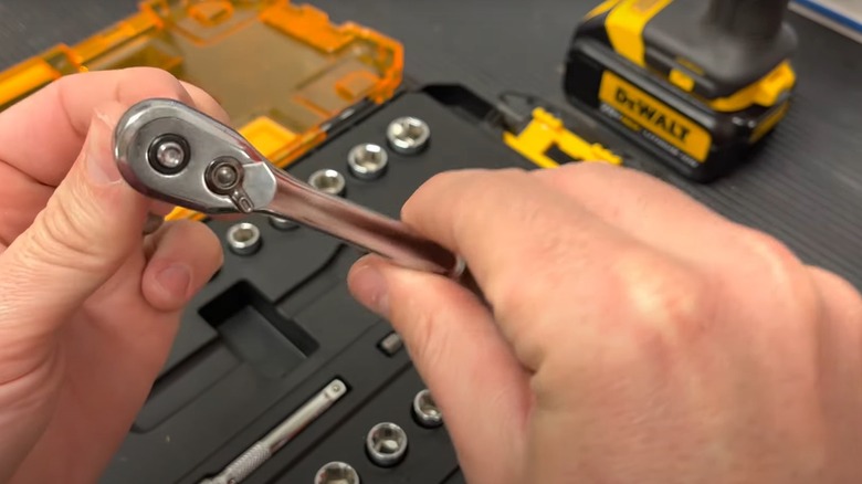 Person adjusting a socket on a DeWalt ratchet