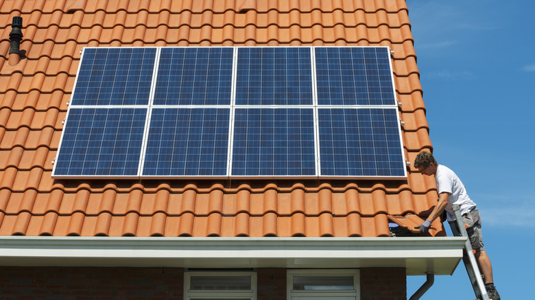 person installing solar panels