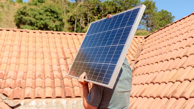 Man carrying a solar panel