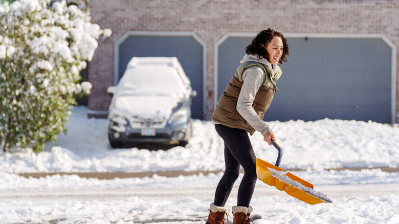 A person shovels snow in their neighborhood.