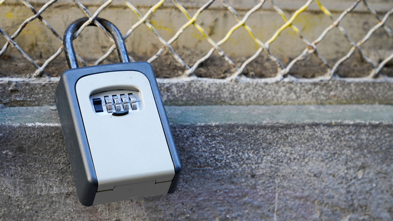 Key lock box padlocked to a fence