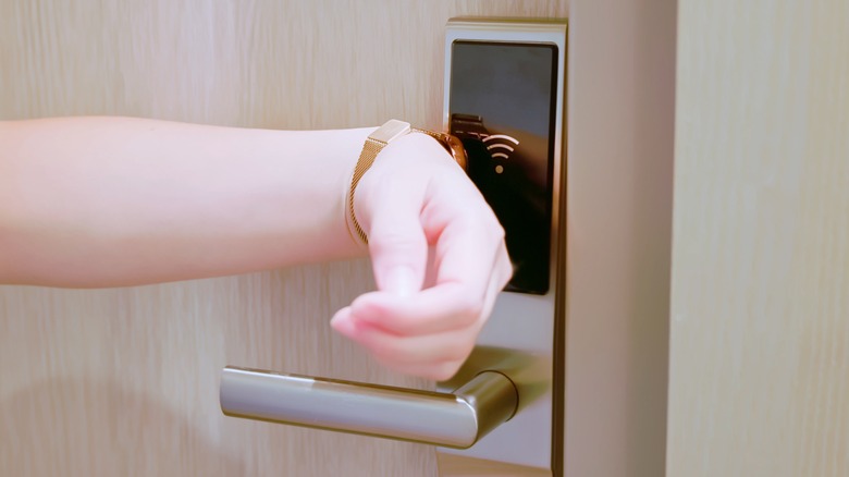 Woman opening a door with a watch