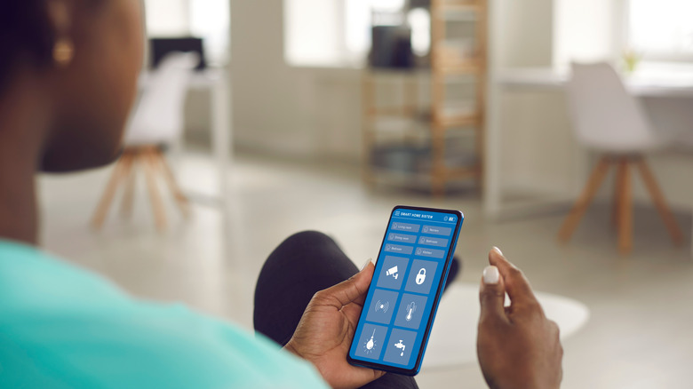 Woman holding phone with smart app