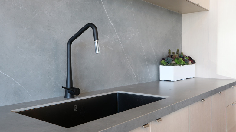 Black faucet in kitchen