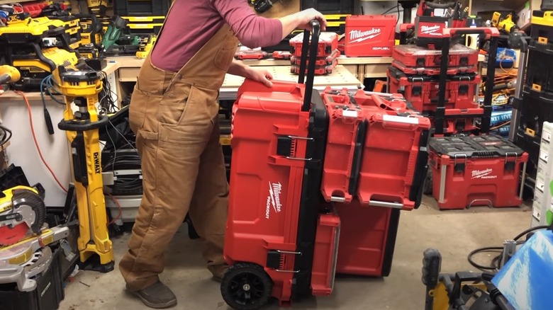 man stacking milwaukee packout tool boxes