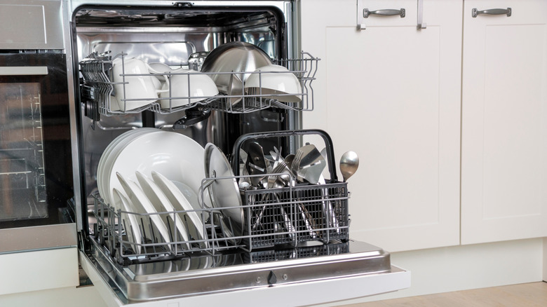 Opened dishwasher with dishes inside