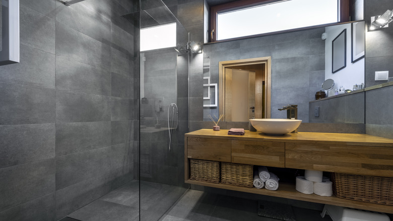 Dark grey bathroom with shower room and wood vanity