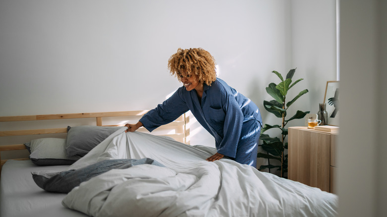 Woman making bed