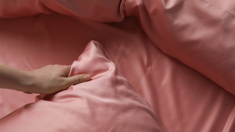 Pink silk bedding on bed