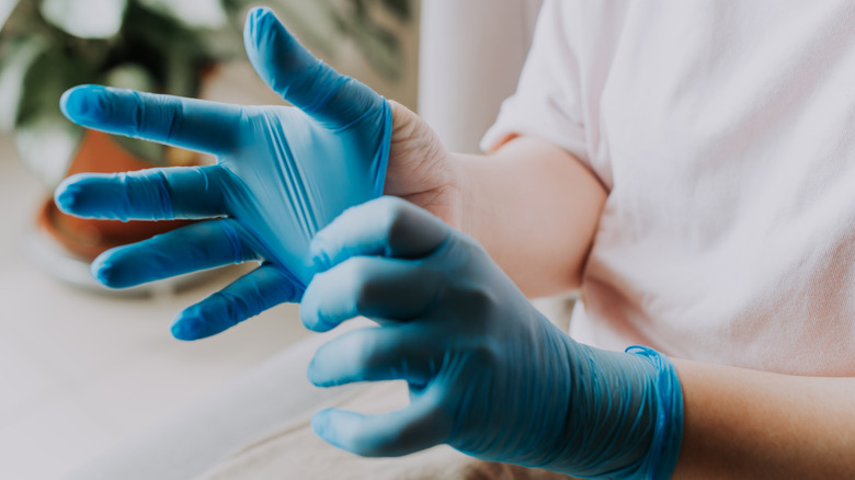 person wearing rubber gloves