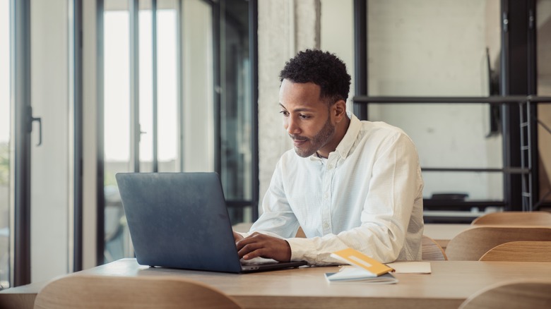 man typing on computer