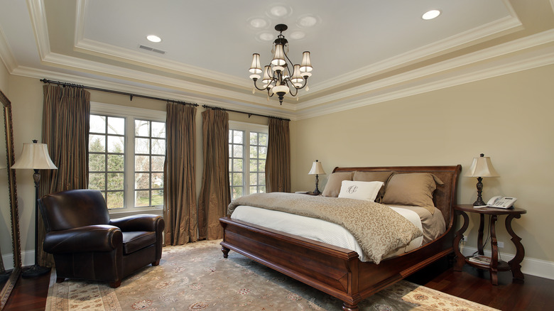 Furnished bedroom with tray ceiling