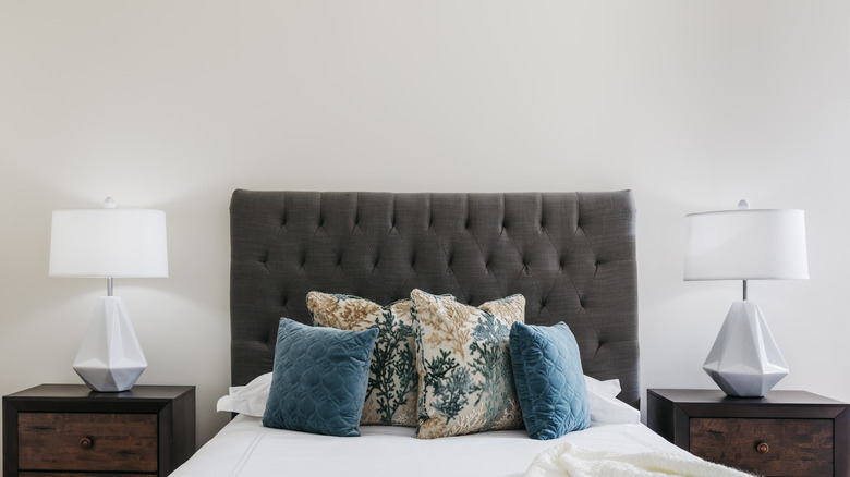 Tufted headboard with throw pillows