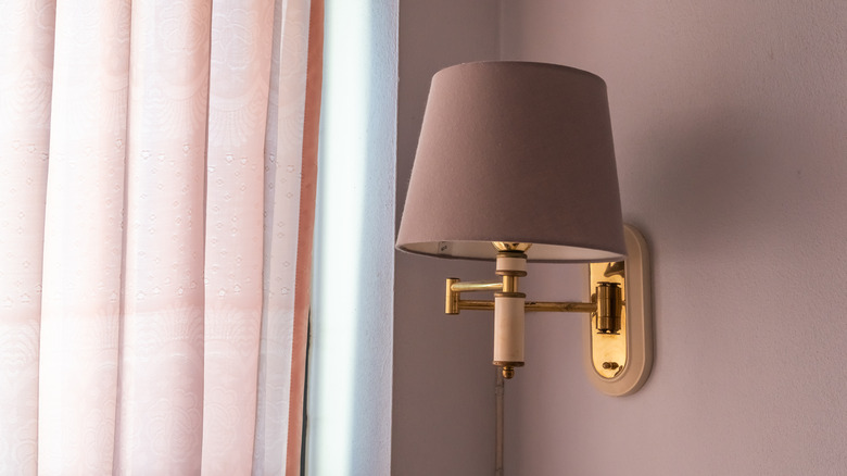 Brown sconce and pink curtains