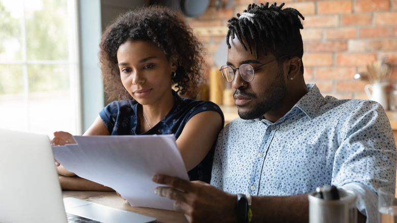 Couple reading real estate contract