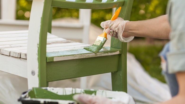 Someone painting a chair