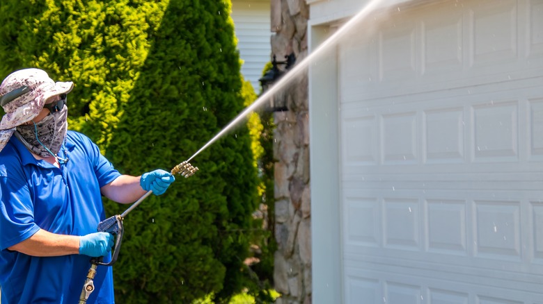 Pressure washing house in summer